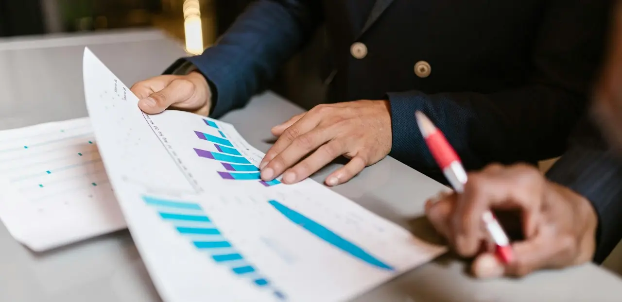 Accountant looking at Investment report with Client